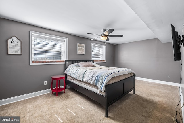 carpeted bedroom with baseboards and ceiling fan