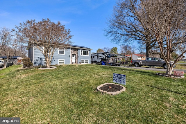 view of front of property with a front yard and solar panels