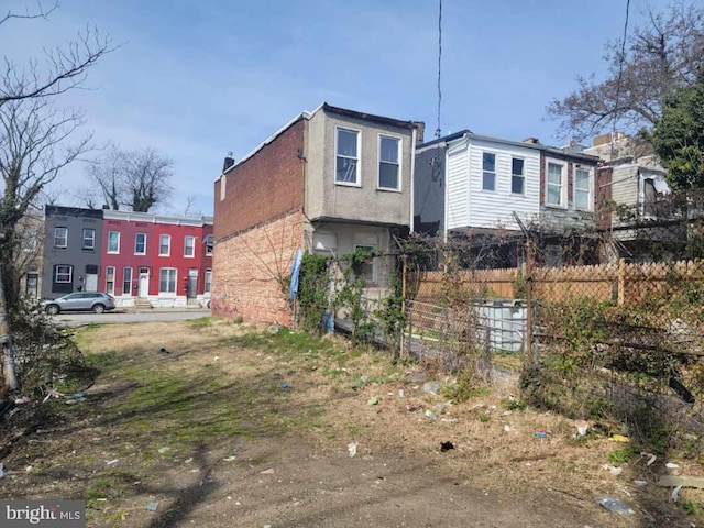 2419 Brentwood Ave, Baltimore, MD 21218 - view of front of house with stucco siding and fence