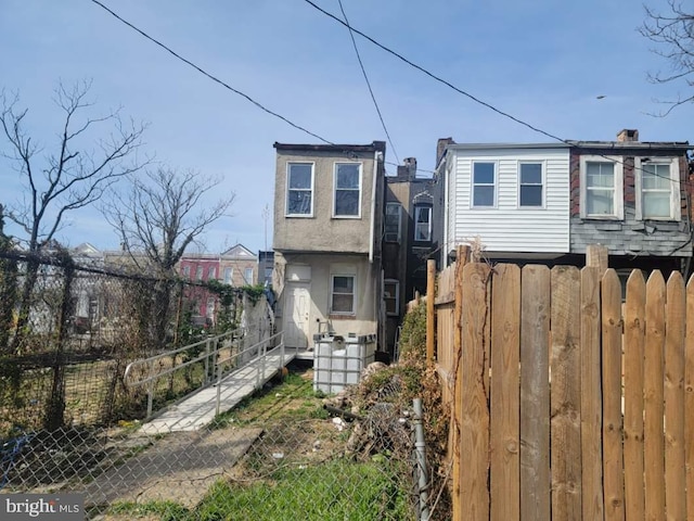 2419 Brentwood Ave, Baltimore, MD 21218 - view of front of property with stucco siding and fence