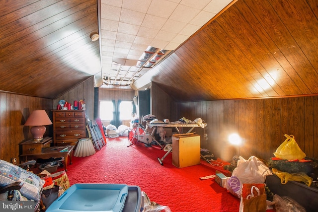 bonus room featuring lofted ceiling, wood walls, carpet floors, and wooden ceiling