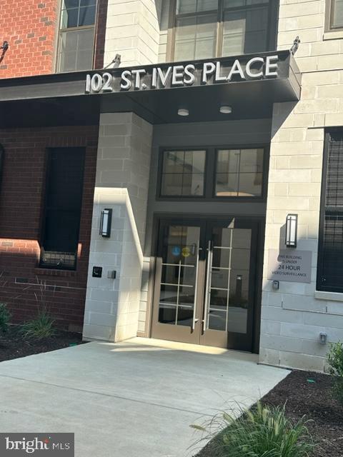 102 Saint Ives Unit 403, National Harbor, MD 20745 - doorway to property featuring french doors and brick siding