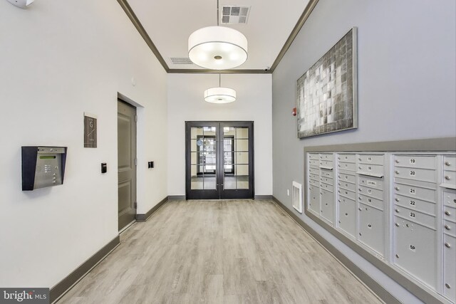 102 Saint Ives Unit 403, National Harbor, MD 20745 - entryway with light wood-type flooring, baseboards, visible vents, and mail area
