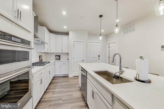 102 Saint Ives Unit 403, National Harbor, MD 20745 - kitchen featuring white cabinetry, stainless steel appliances, a sink, pendant lighting, and visible vents