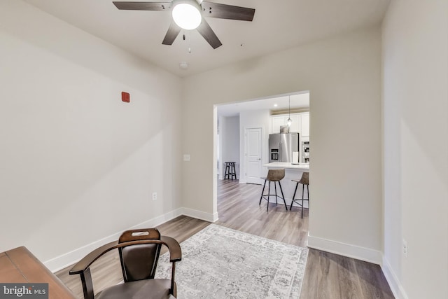 102 Saint Ives Unit 403, National Harbor, MD 20745 - living area featuring a ceiling fan, baseboards, and light wood-style floors