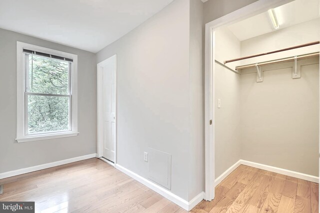 unfurnished bedroom featuring light wood-style flooring and baseboards