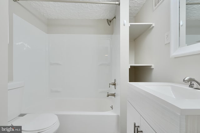 bathroom featuring toilet, a textured ceiling, washtub / shower combination, and vanity