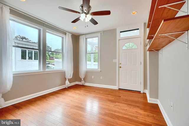 entryway featuring light wood-type flooring, a ceiling fan, baseboards, and recessed lighting