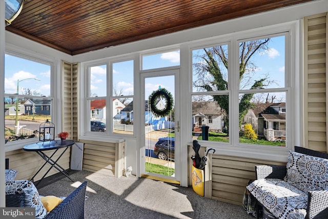 sunroom featuring a residential view