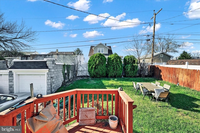 wooden terrace with a garage, a fenced backyard, and a yard