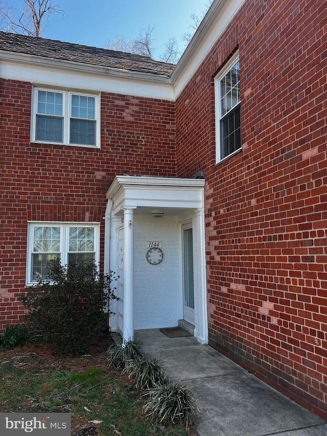property entrance with brick siding