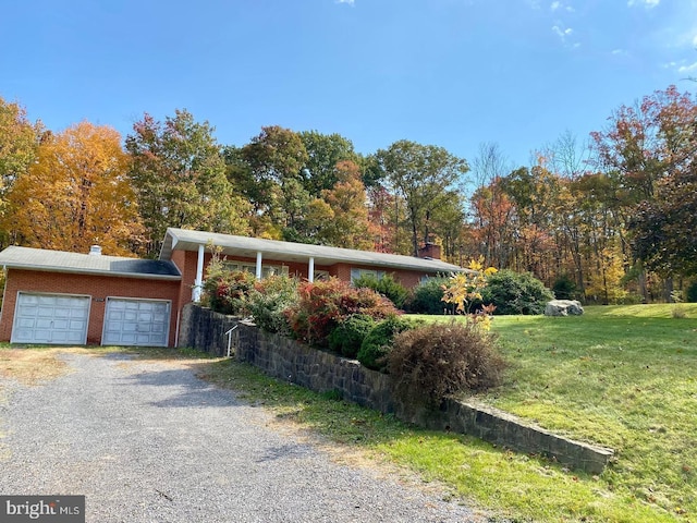 12114 Vale Smt, Frostburg, MD 21532 - exterior space featuring brick siding, gravel driveway, a front lawn, a chimney, and a garage
