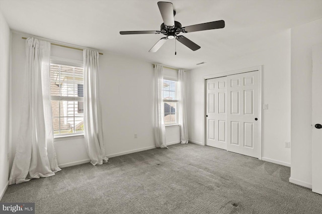 unfurnished bedroom featuring carpet floors, baseboards, and ceiling fan