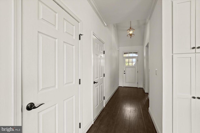 hallway featuring baseboards and dark wood-style floors