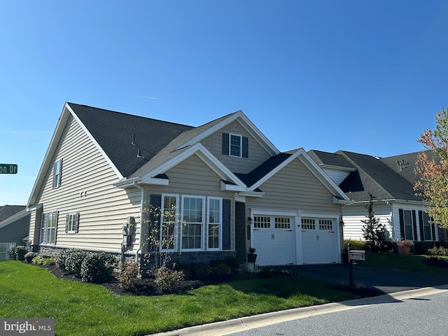 craftsman-style house with a garage, a front lawn, stone siding, roof with shingles, and driveway