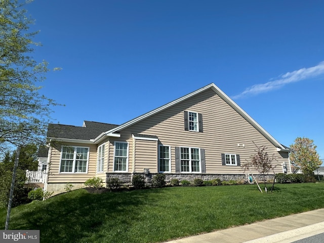 view of home's exterior with a lawn