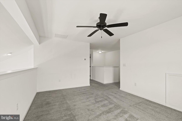 interior space with visible vents, a ceiling fan, carpet, and baseboards
