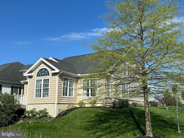 view of property exterior with a lawn