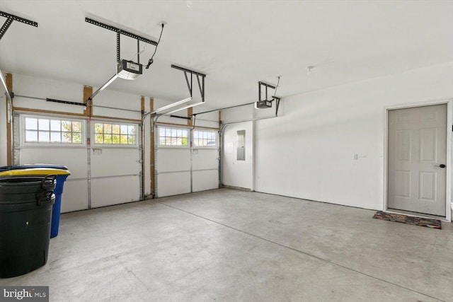 garage with a garage door opener and electric panel