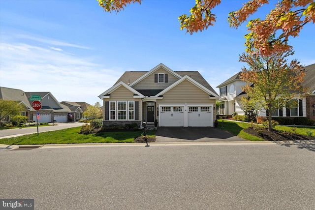 craftsman inspired home with a garage and driveway
