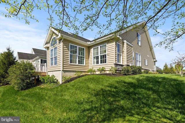 view of property exterior with a lawn