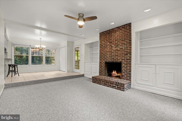 17 Alexandria Overlook Dr, Oxon Hill, MD 20745 - unfurnished living room featuring ceiling fan with notable chandelier, built in features, recessed lighting, a fireplace, and carpet flooring
