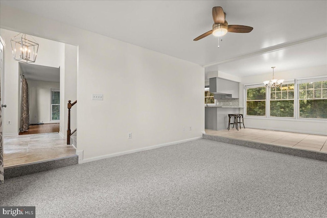 17 Alexandria Overlook Dr, Oxon Hill, MD 20745 - unfurnished living room featuring baseboards, carpet, and ceiling fan with notable chandelier