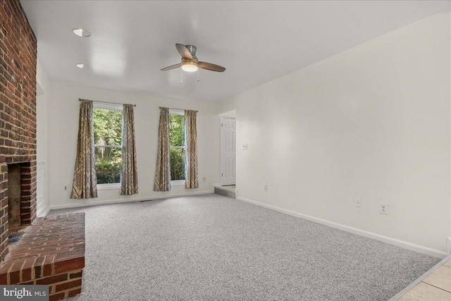 17 Alexandria Overlook Dr, Oxon Hill, MD 20745 - unfurnished living room featuring a brick fireplace, a ceiling fan, baseboards, and carpet floors
