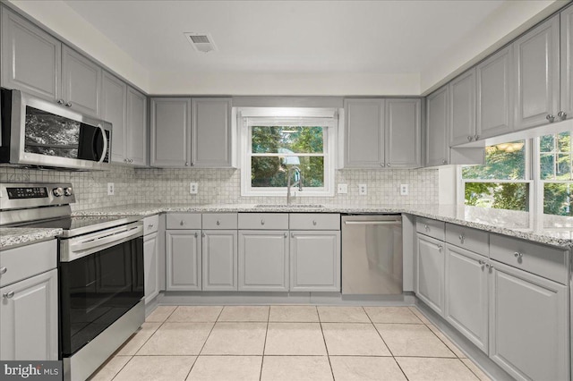 17 Alexandria Overlook Dr, Oxon Hill, MD 20745 - kitchen featuring tasteful backsplash, visible vents, gray cabinets, stainless steel appliances, and a sink