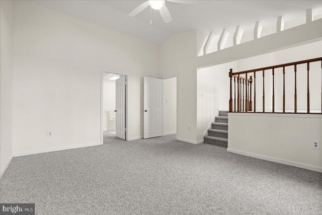 17 Alexandria Overlook Dr, Oxon Hill, MD 20745 - carpeted empty room featuring stairway, baseboards, high vaulted ceiling, and ceiling fan