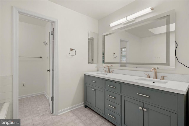 17 Alexandria Overlook Dr, Oxon Hill, MD 20745 - bathroom featuring double vanity, baseboards, and a sink