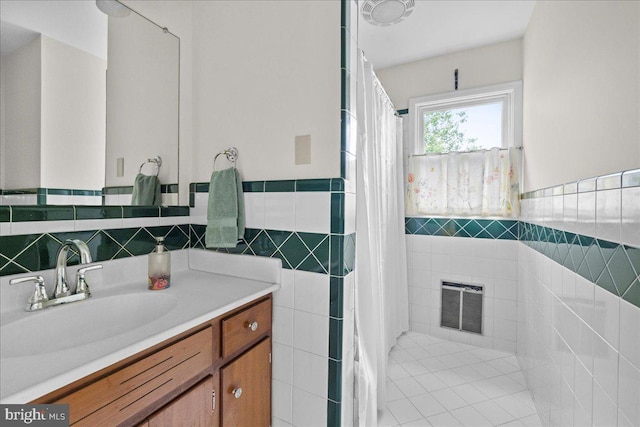 331 Ridge Ave, Winchester, VA 22601 - full bathroom with tile walls, vanity, wainscoting, curtained shower, and tile patterned flooring