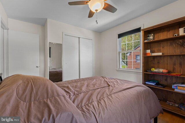 bedroom featuring a closet, a ceiling fan, and wood finished floors