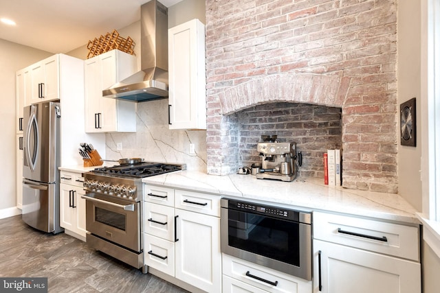 21 N Collington Ave N, Baltimore, MD 21231 - kitchen with stainless steel appliances, wall chimney range hood, decorative backsplash, light stone counters, and recessed lighting
