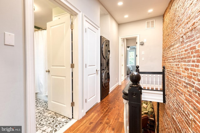 21 N Collington Ave N, Baltimore, MD 21231 - hall featuring stacked washer / drying machine, brick wall, light wood finished floors, and recessed lighting