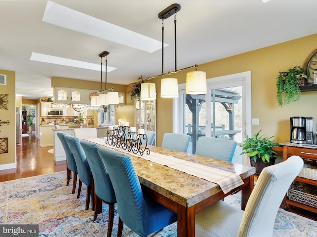 dining room with light wood-style floors and visible vents