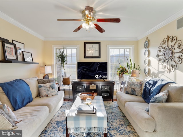 living area featuring ornamental molding, wood finished floors, and ceiling fan