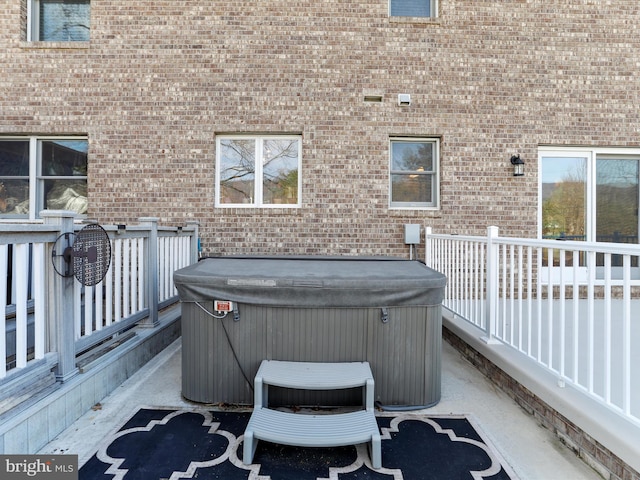 view of patio / terrace with a wooden deck and a hot tub