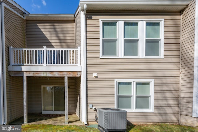 rear view of house with central AC unit