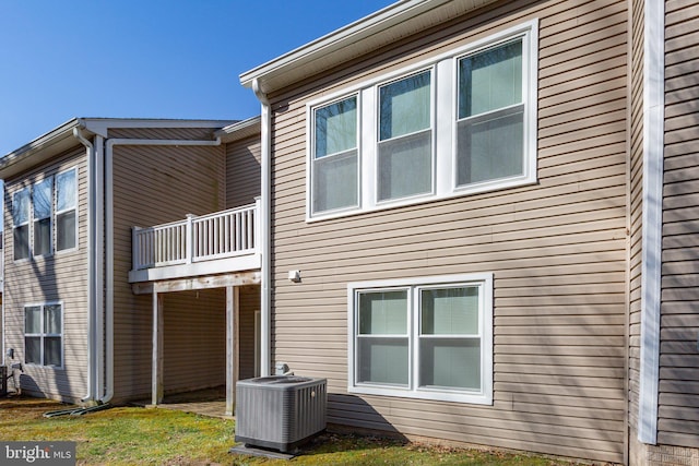 view of home's exterior featuring a balcony and central AC unit