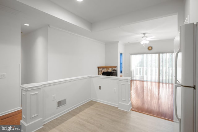 unfurnished room with recessed lighting, ceiling fan, light wood-style flooring, visible vents, and a fireplace