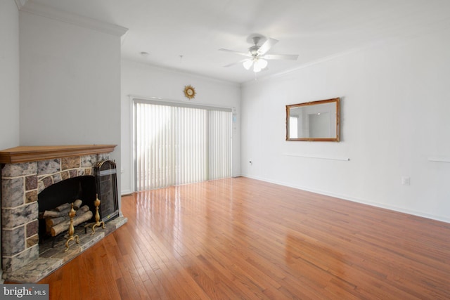 living room featuring a stone fireplace, ceiling fan, ornamental molding, and hardwood / wood-style flooring