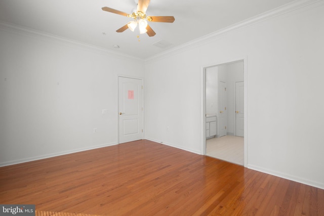 unfurnished bedroom featuring baseboards, ornamental molding, and wood finished floors