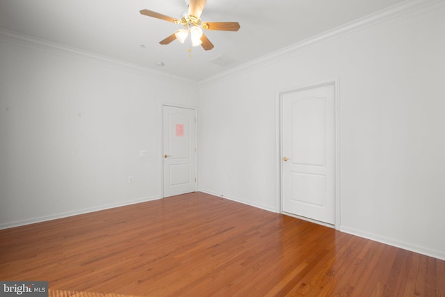 unfurnished room with ornamental molding, baseboards, ceiling fan, and wood finished floors