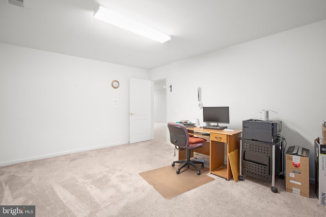 carpeted office featuring baseboards