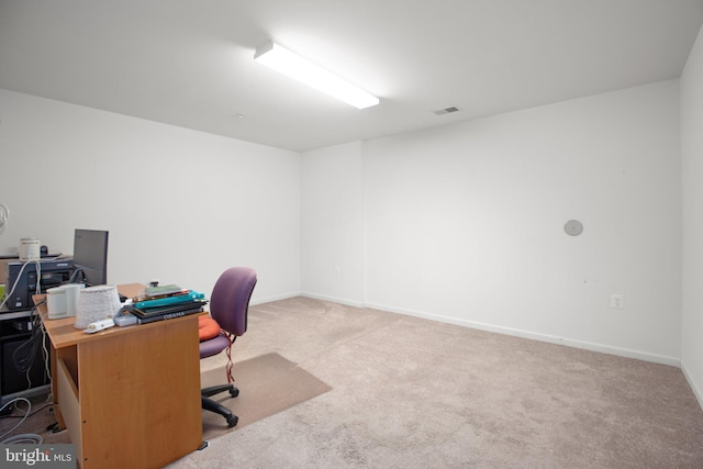 home office with carpet floors, baseboards, and visible vents