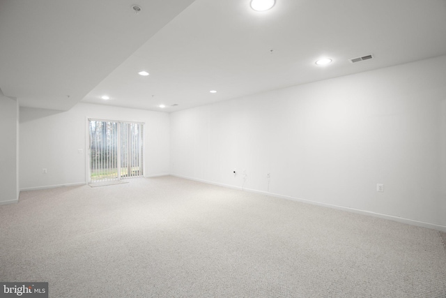 unfurnished room with recessed lighting, light carpet, baseboards, and visible vents