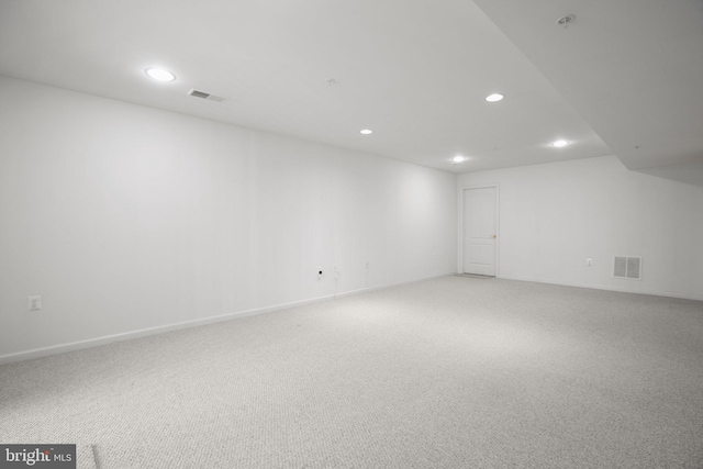 spare room featuring carpet flooring, visible vents, baseboards, and recessed lighting