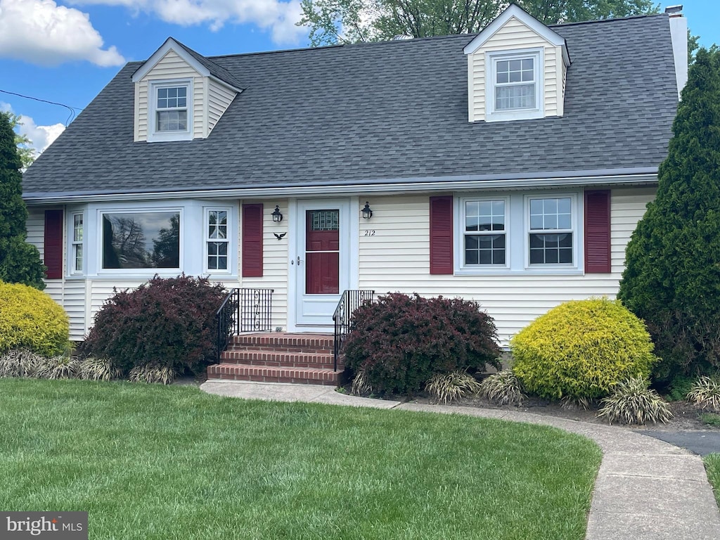 212 Nancy Ln, Ewing, NJ 08638 - new england style home with a front yard and roof with shingles