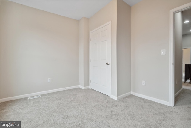 unfurnished bedroom with carpet flooring, baseboards, and visible vents